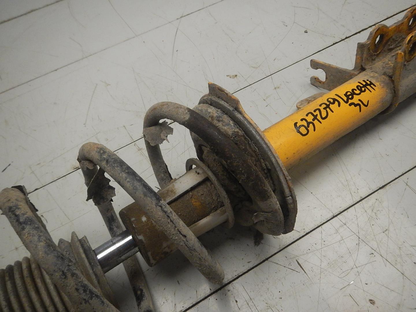 Амортизатор задний левый