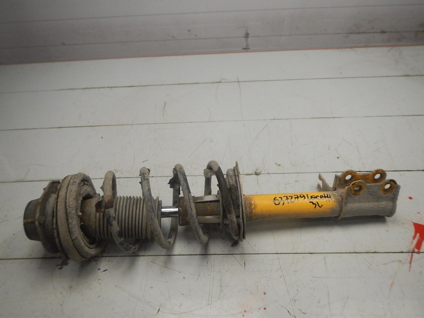 Амортизатор задний левый